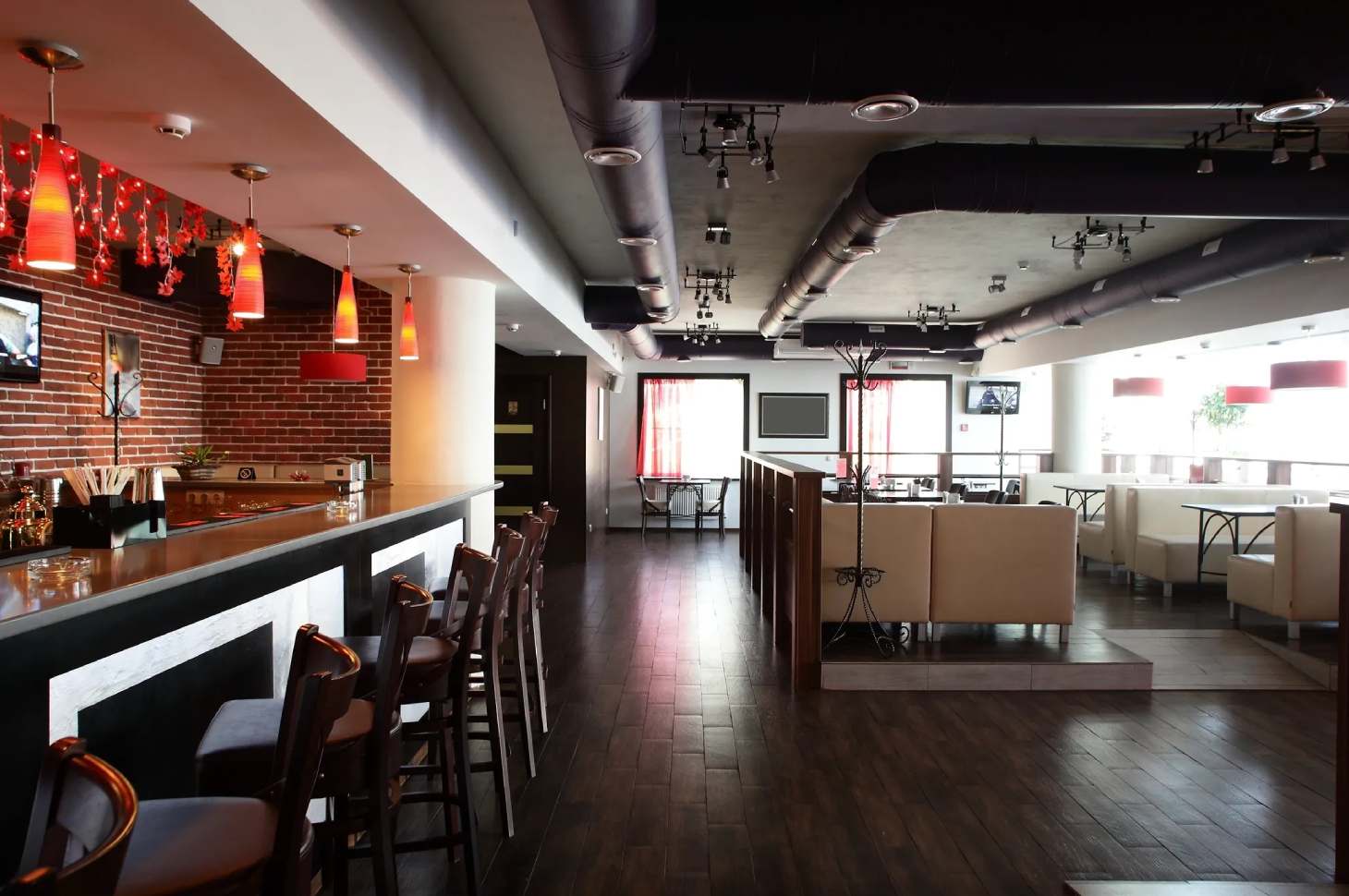 A restaurant with wooden floors and tables