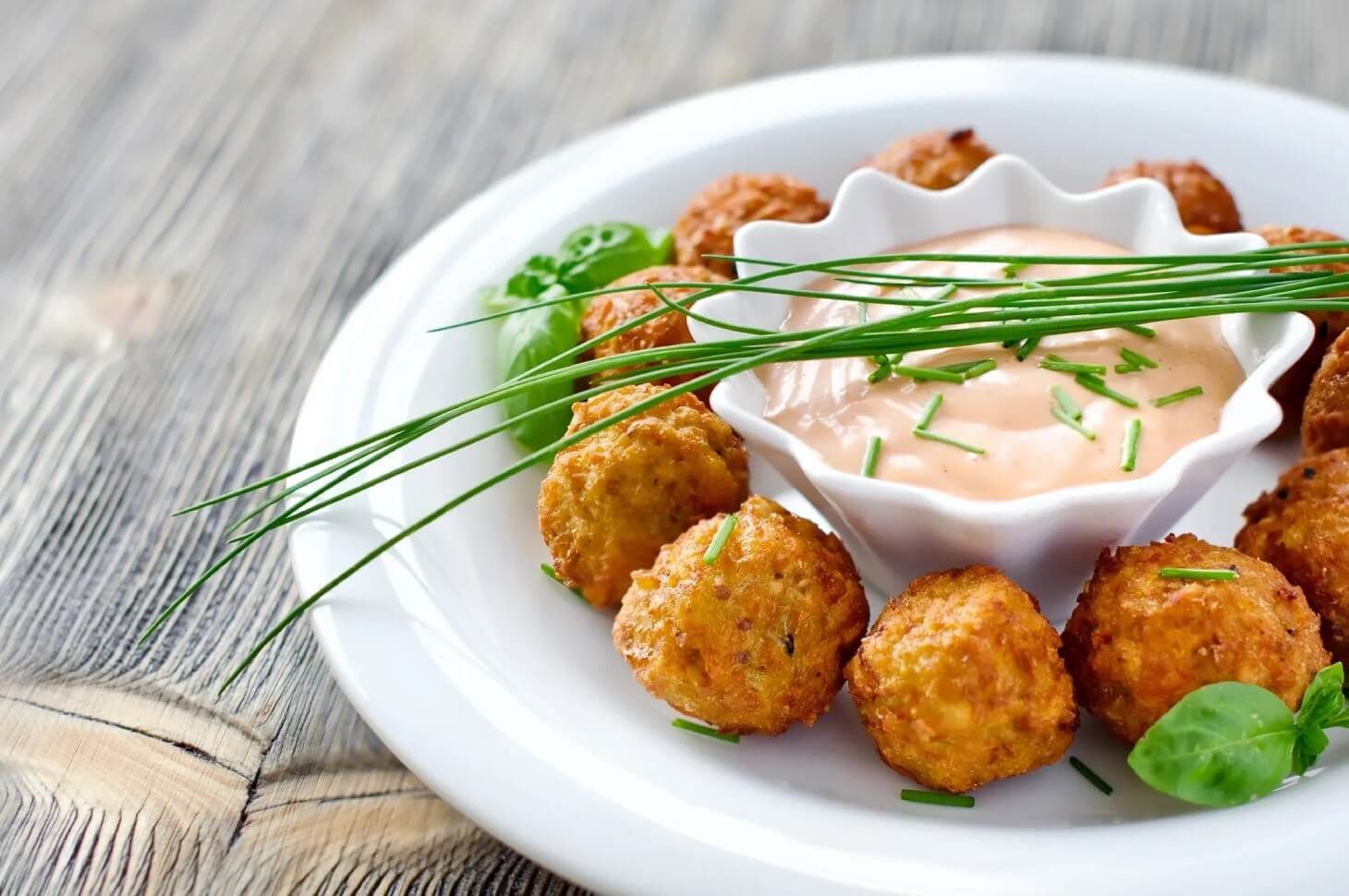 A white plate topped with some fried food.