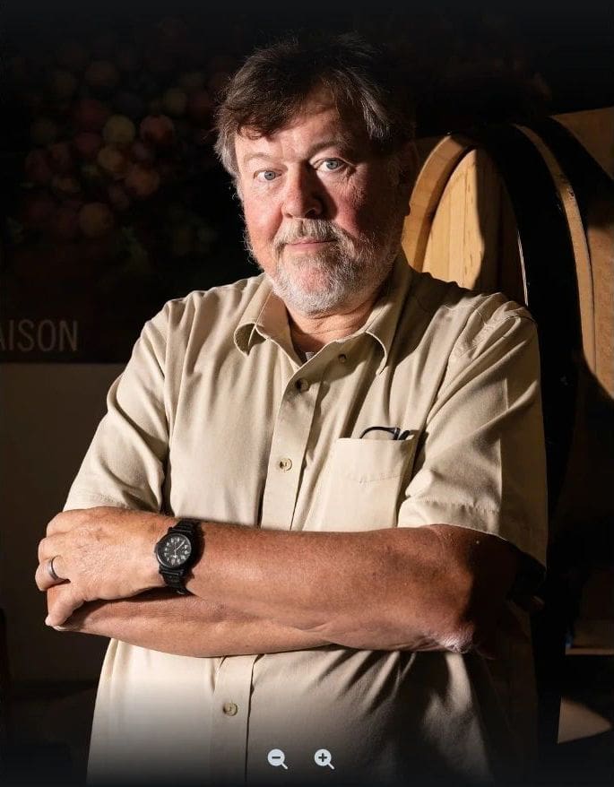 A man with his arms crossed wearing a watch.