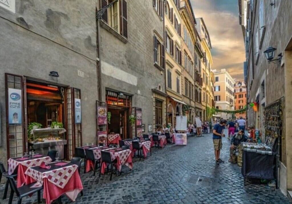 A street with tables and chairs on the side of it.