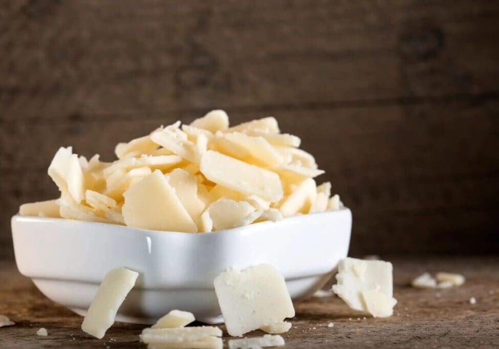 A bowl of white cheese sitting on top of a table.