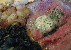 Roasted beef with herb butter and sides.